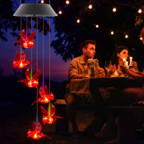 TSIPEKLO outdoor chime hanging on a tree adds warm red glow