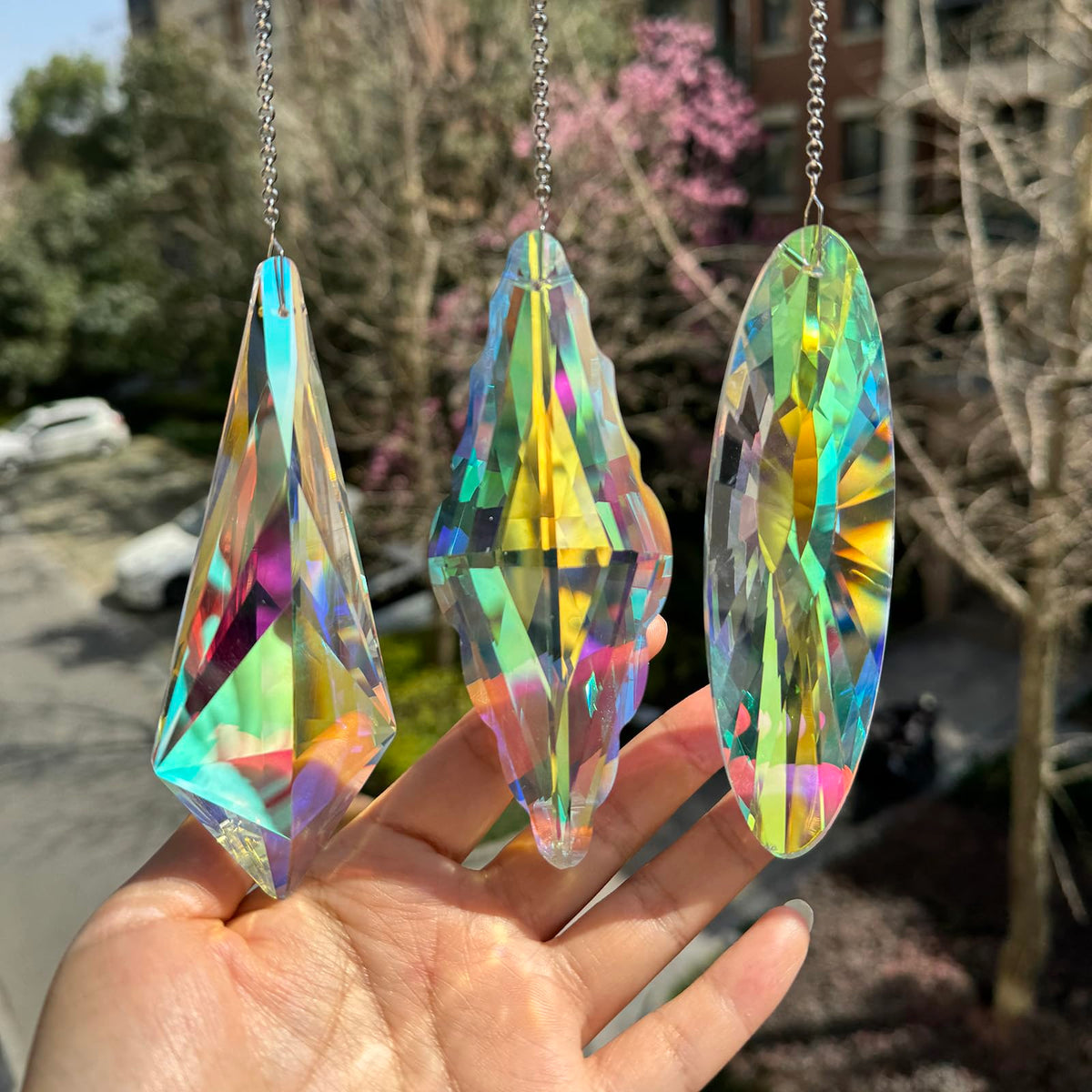 TXXNSM 3-piece crystal sun catchers in window casting vibrant rainbows.