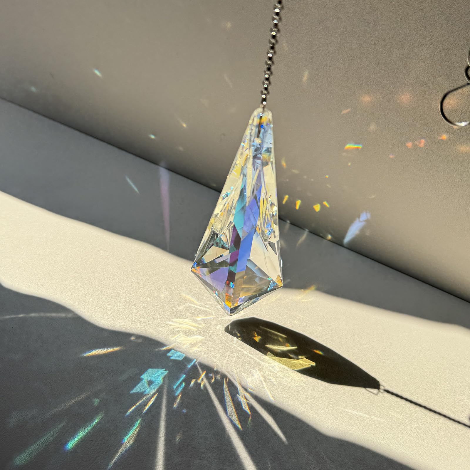 TXXNSM window display projects rainbow colors across walls and surfaces.