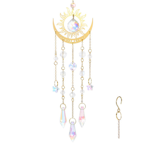 Tyqour crystal suncatcher with a gold flame moon pendant catching sunlight indoors to reveal a rainbow.