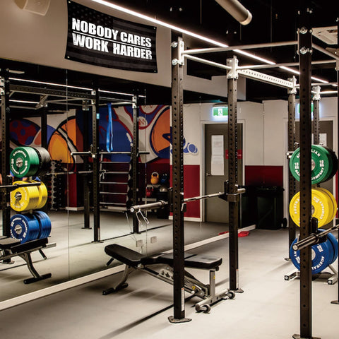 UCNMWBJ Nobody Cares Work Harder flag garage setup inspires consistent training sessions.