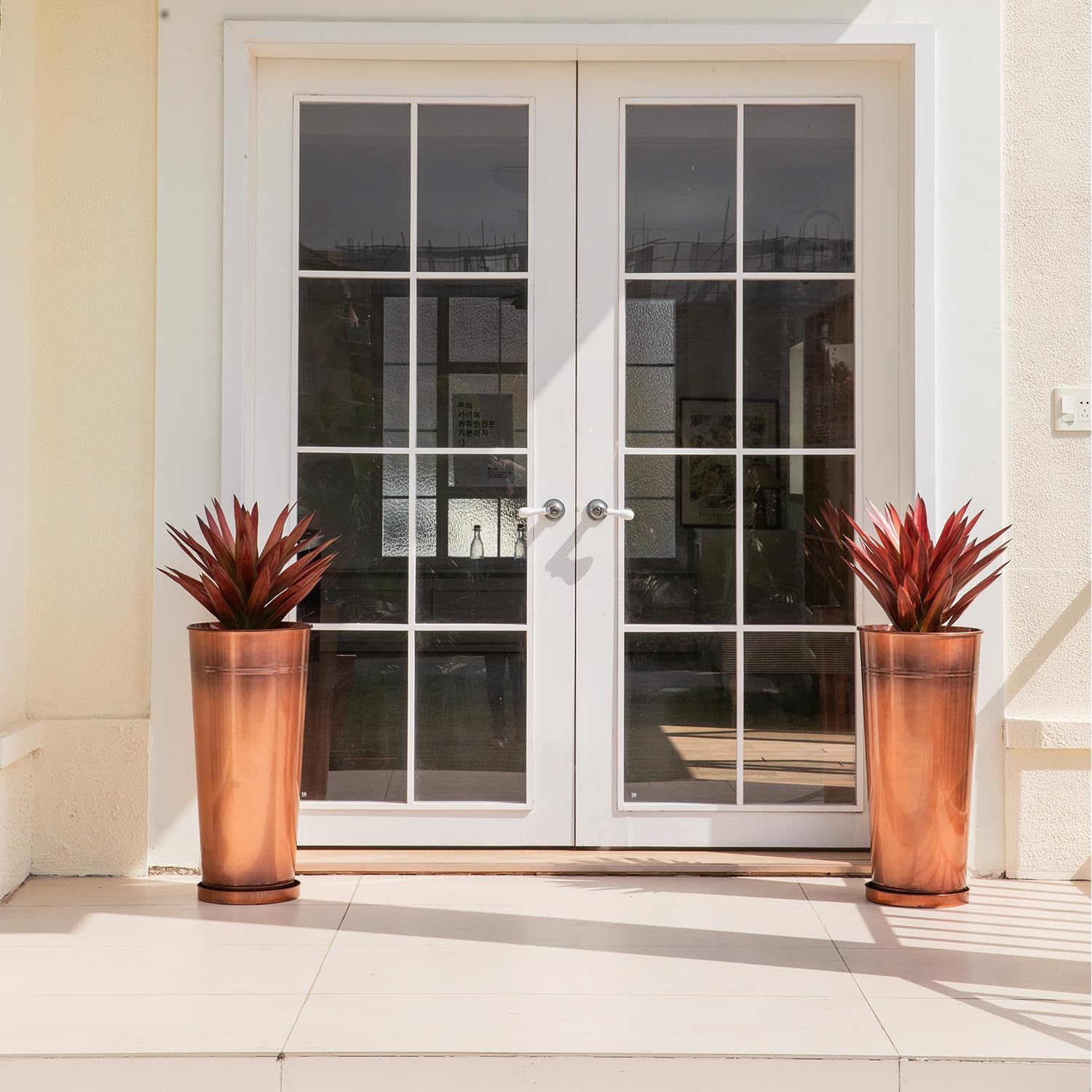 UltiTeque copper planter saucers with holes for mess-free watering.