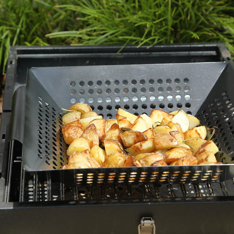 UNCO grill basket in use with vegetables and seafood on the grill.