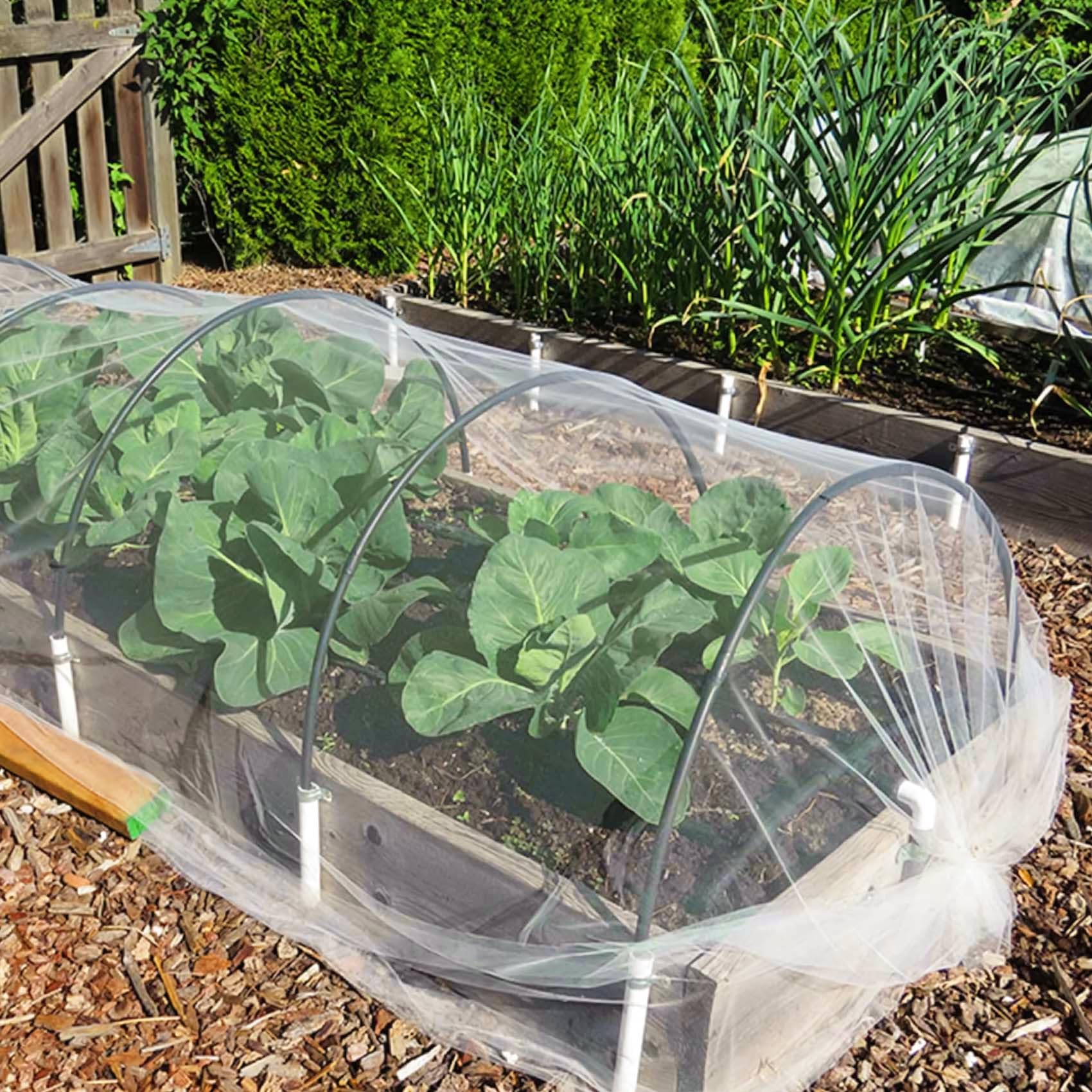 Unves garden netting around a pond edge for pest deterrence and clean edges