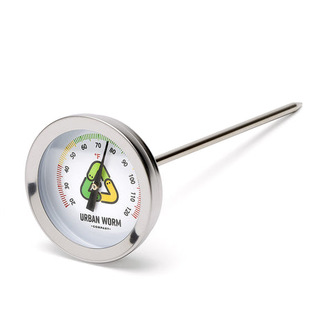 Urban Worm soil thermometer with five-inch stem in soil showing color-coded ticks for easy monitoring.