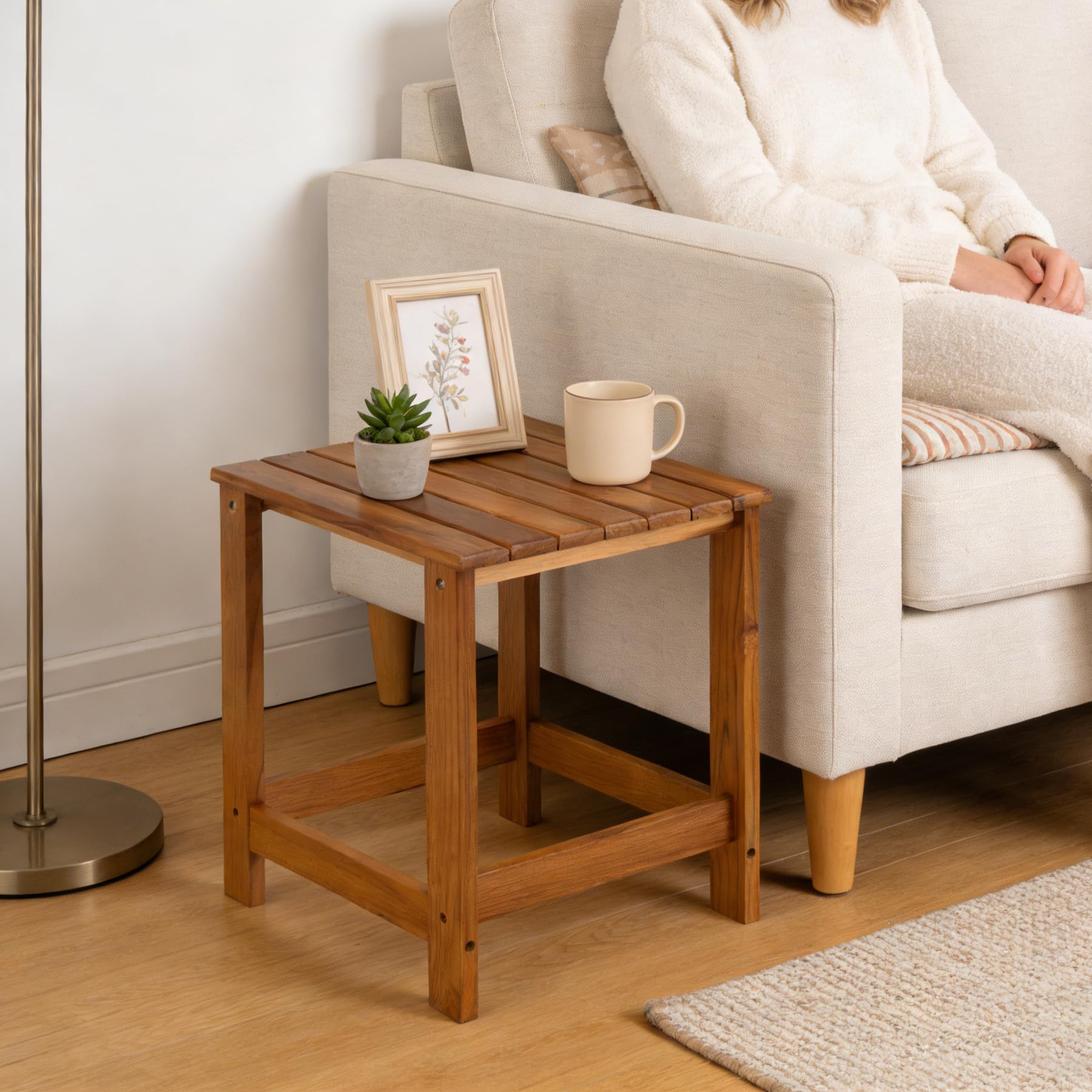 Utoplike teak side table in garden beside potted plants