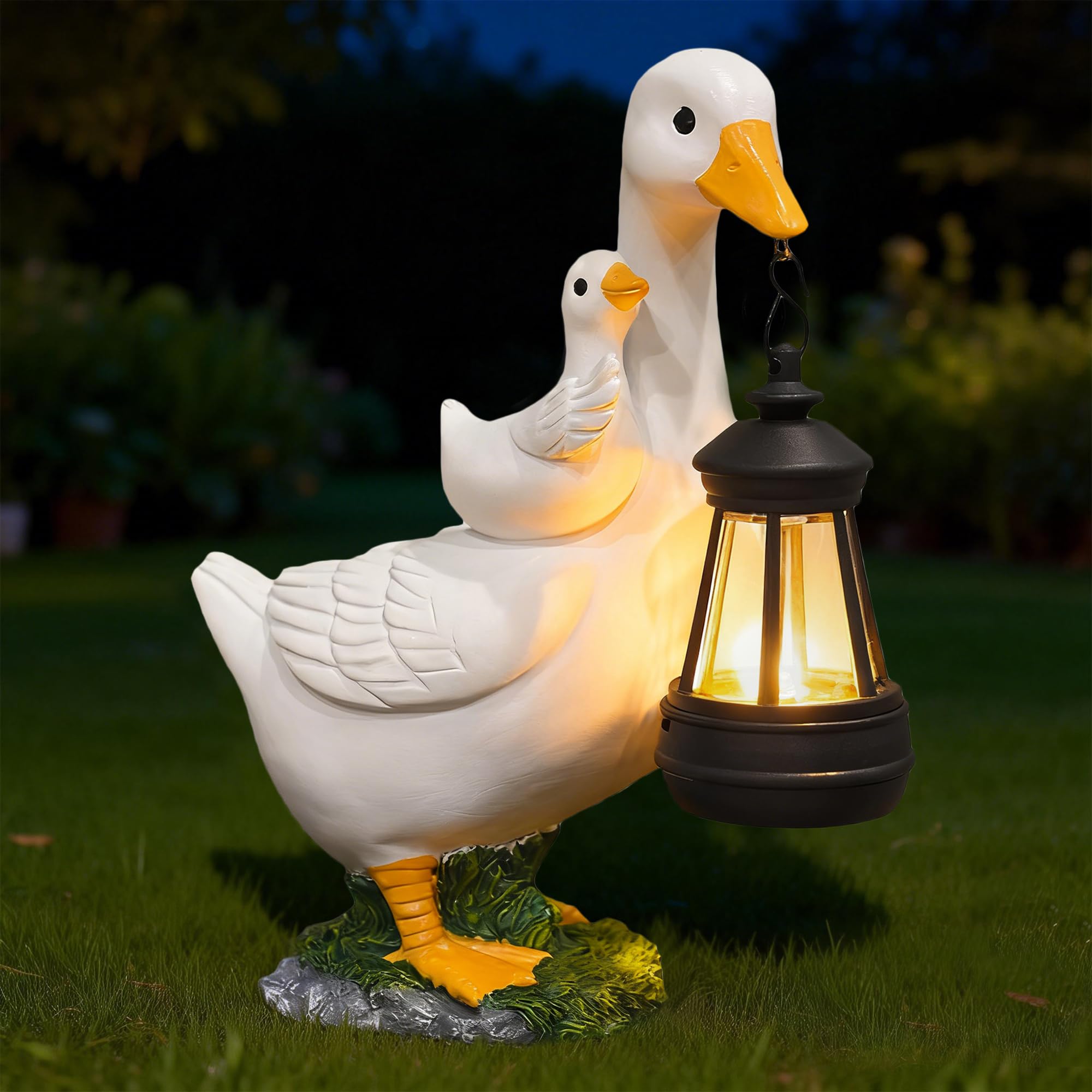 ViQuHaT goose statue with solar lantern lighting along a garden path