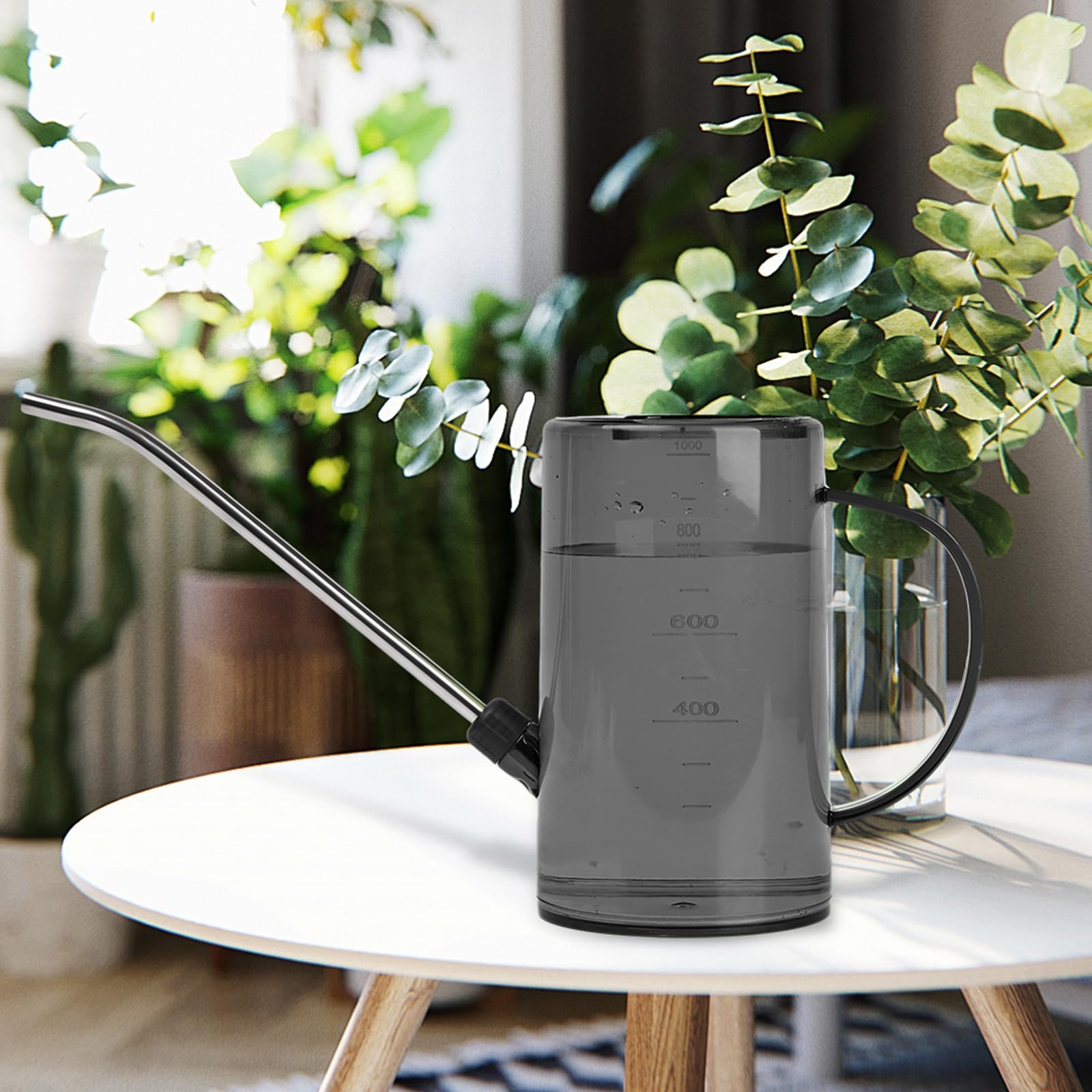 VKPLITE watering can in use watering desk-side plants