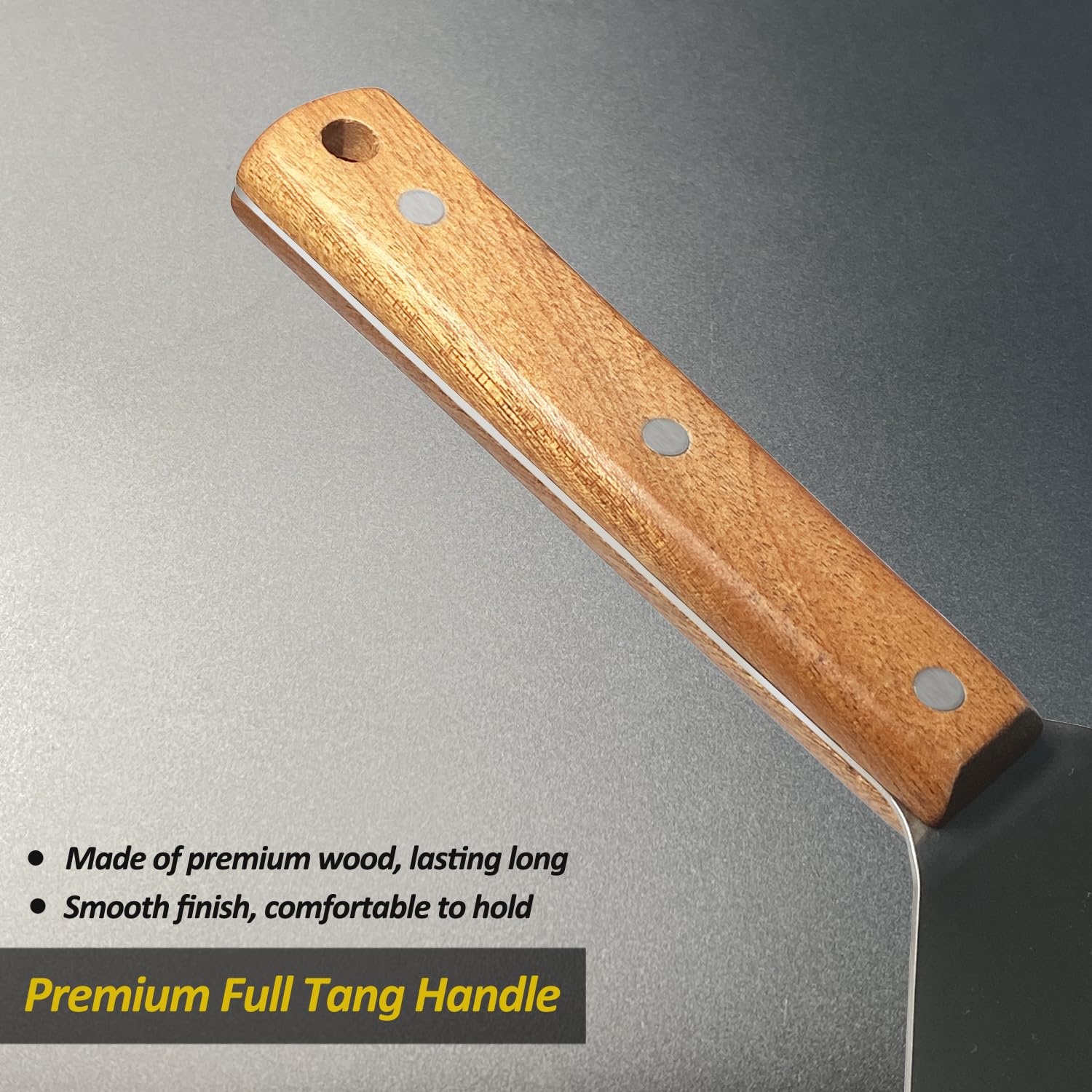 Vovoly metal spatula being used to scrape a pan.