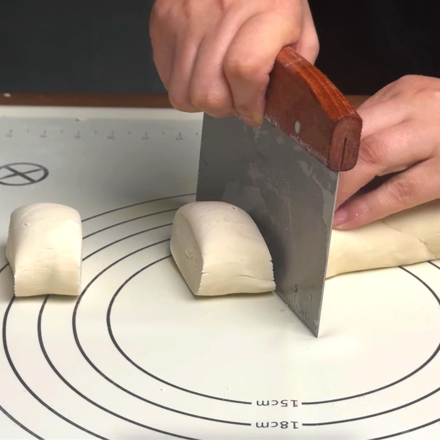 Vovoly bench scraper in action for transferring ingredients to bowls
