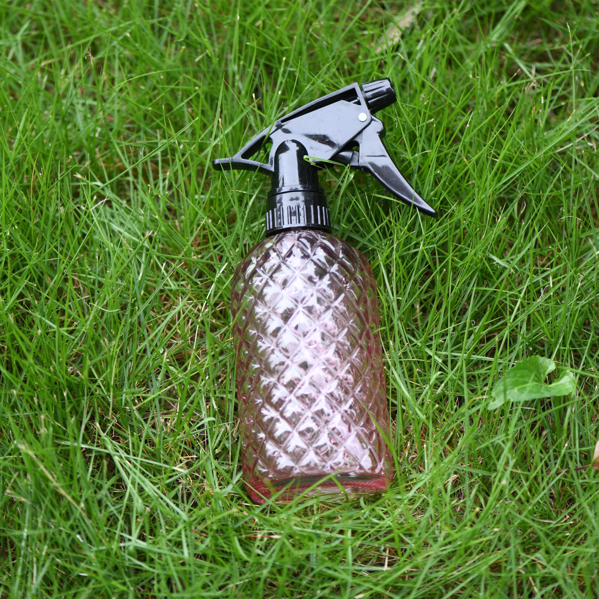 Wartter pink glass bottle adds style to gardening tasks.