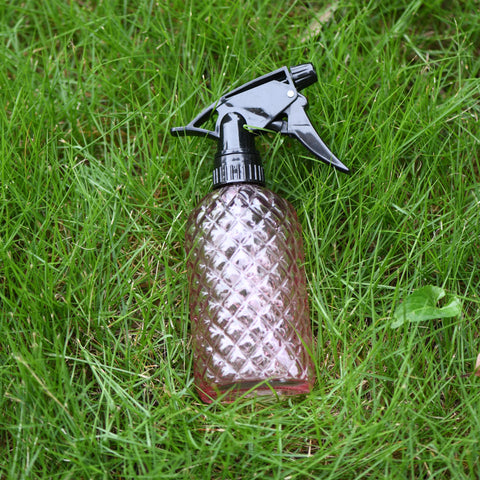 Wartter pink glass bottle adds style to gardening tasks.