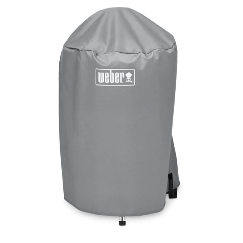 Weber 18-inch charcoal kettle grill cover with lightweight fabric and secure straps for windy protection.