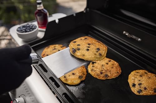 Weber carbon steel griddle with rimmed edges keeps oil and seasonings in place