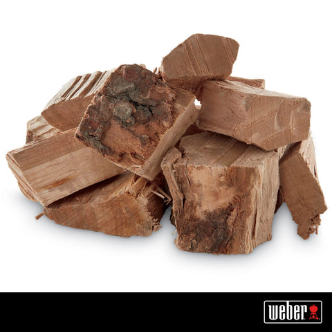 Weber Cherry Wood Chunks on grill releasing steady, aromatic smoke.