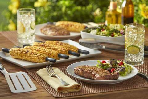 Weber corn picks during an outdoor barbecue for quick serving.