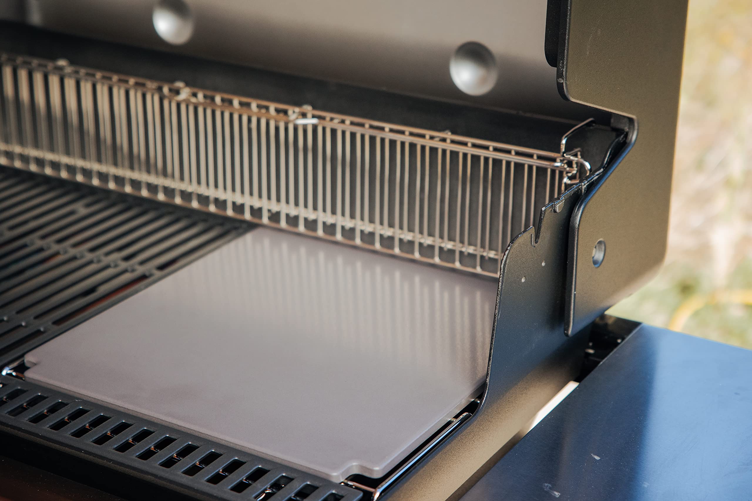Weber Crafted pizza on grill close-up highlighting bubbling cheese.