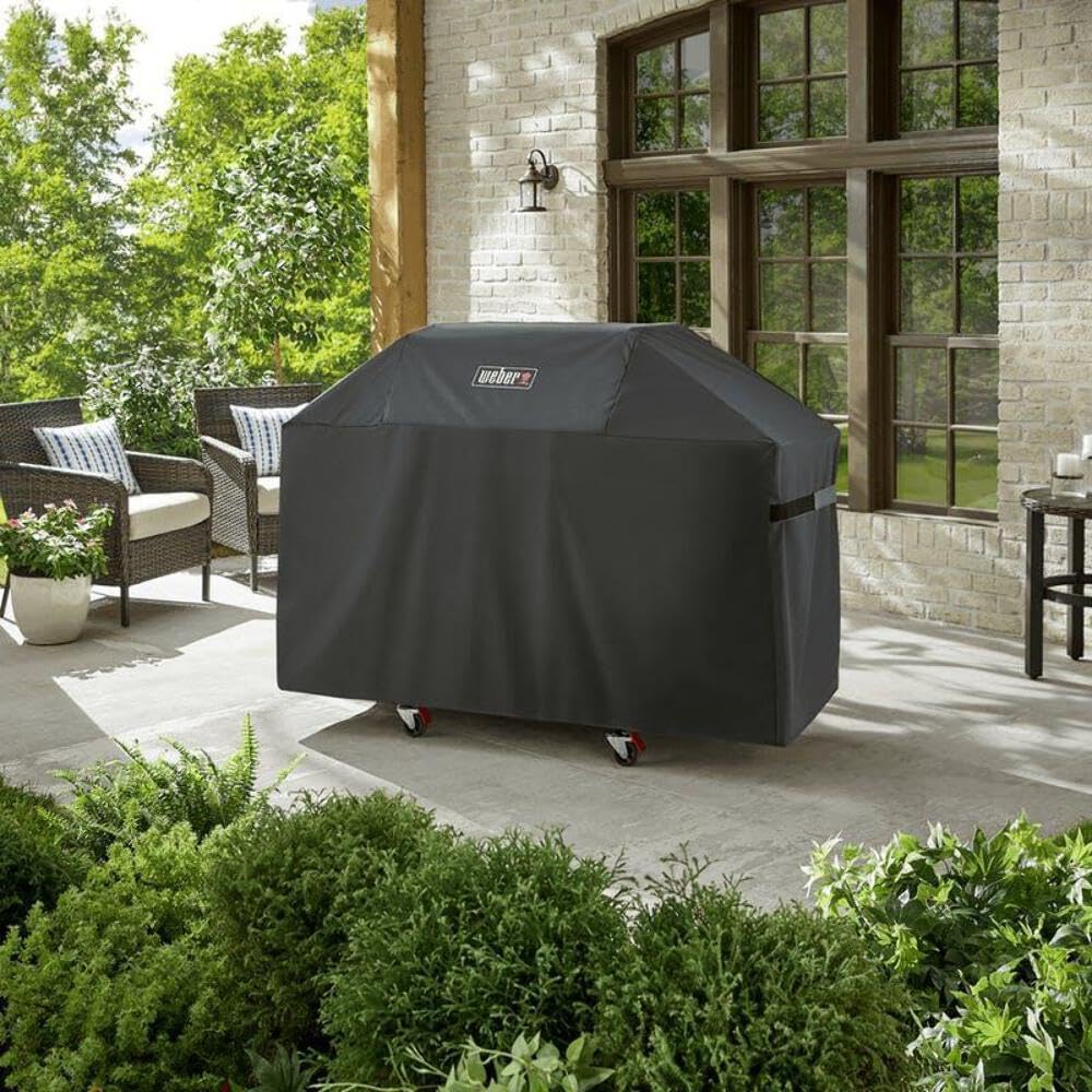 Weber cover side view showing secure straps for windy weather.