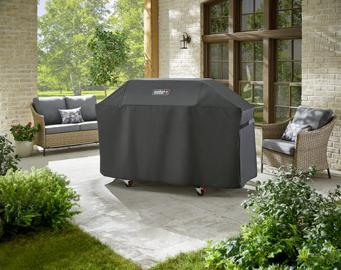 Weber Genesis 400 Series grill cover showing fastening straps for secure fit