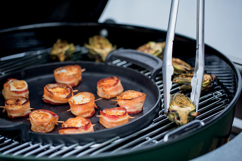 Weber Gourmet BBQ Griddle in use over charcoal grill for even searing