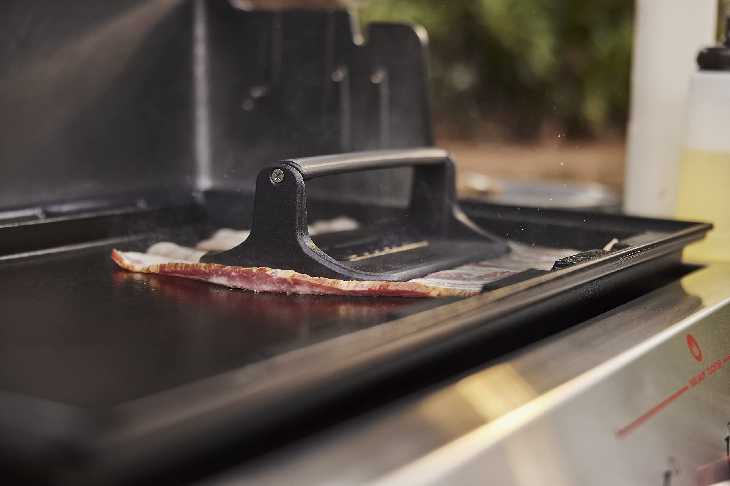 Weber Griddle Press crafted from cast iron for durable, long-lasting use.