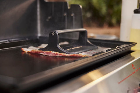 Weber Griddle Press crafted from cast iron for durable, long-lasting use.