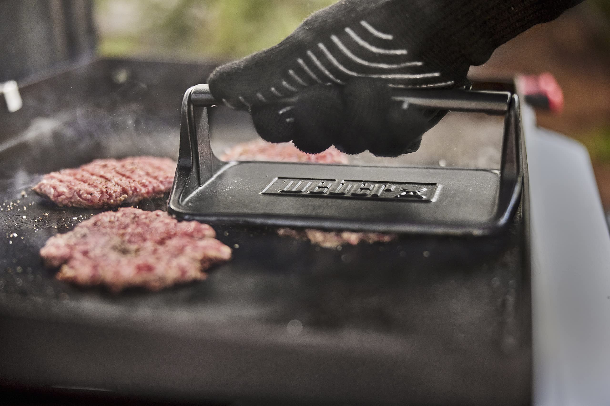 Weber Griddle Press shown beside a clean surface for easy maintenance.