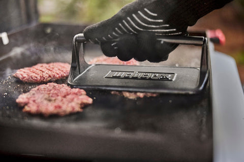 Weber Griddle Press shown beside a clean surface for easy maintenance.