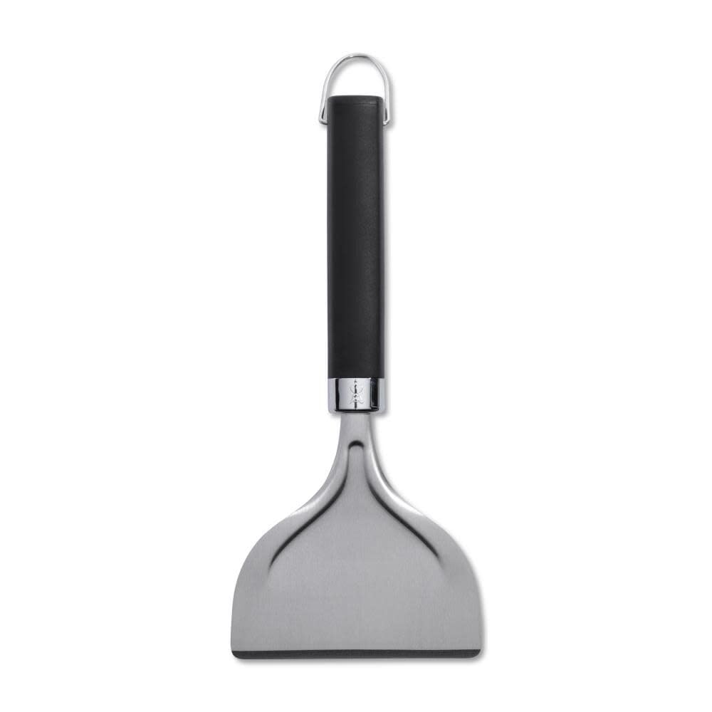 Weber griddle scraper with easy grip handle in use for precise scraping.