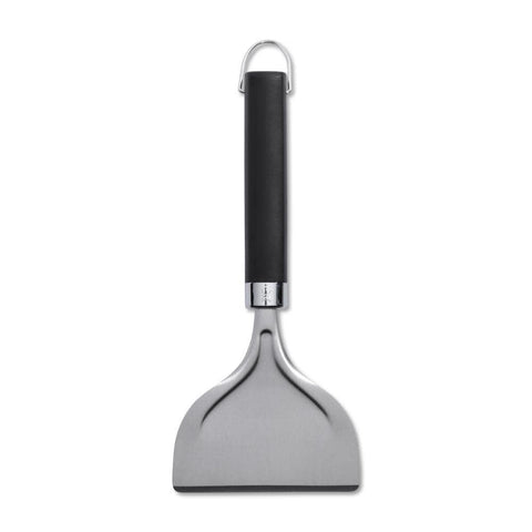 Weber griddle scraper with easy grip handle in use for precise scraping.