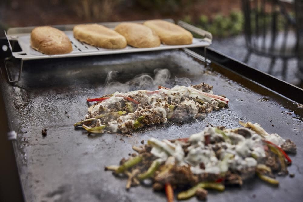 Weber Griddle Warming Rack burgers kept warm with raised back edge.