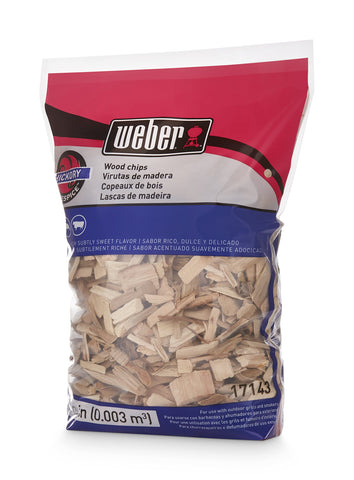 Weber Hickory chips on grill grate delivering rich smoke.