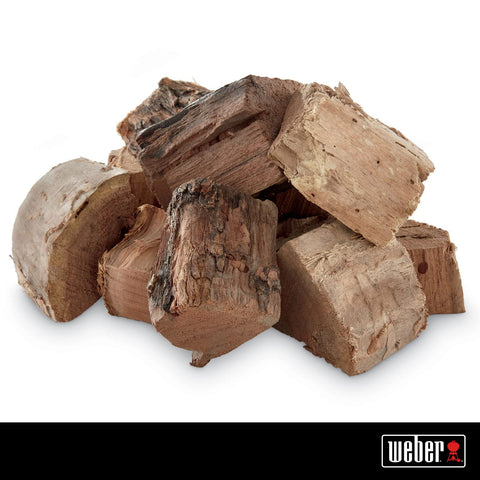 Weber Mesquite wood chunks bag closeup showing chunky texture for steady heat