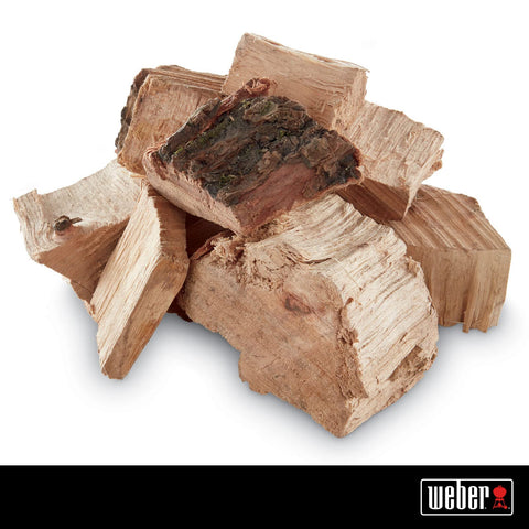 Close-up of Weber Pecan wood chunks delivering rich aroma.