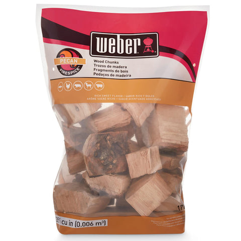 Weber Pecan wood chunks on grill enhancing beef and poultry.