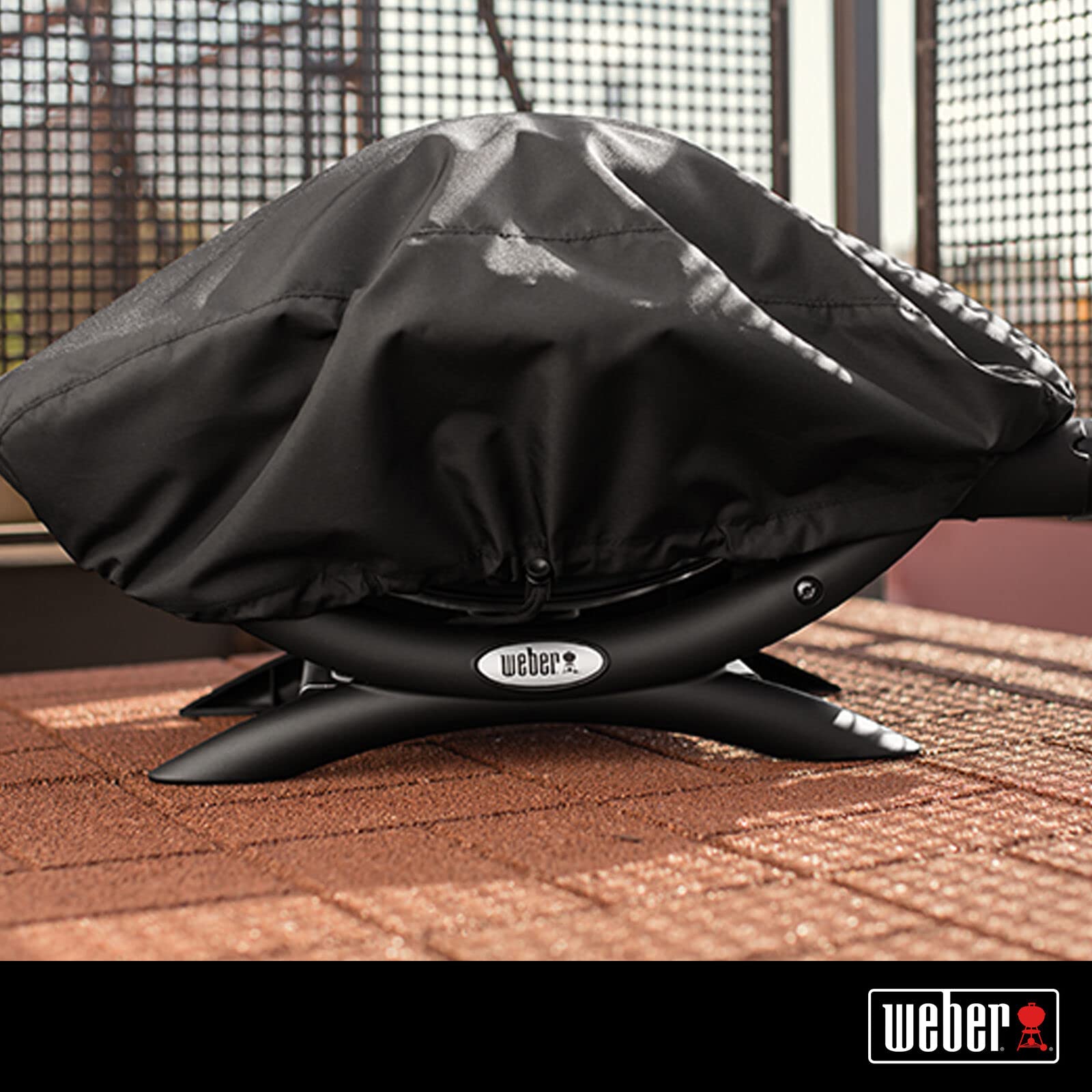 Weber Premium Bonnet Cover Q1000/100 in black close-up shows waterproof, UV-resistant fabric
