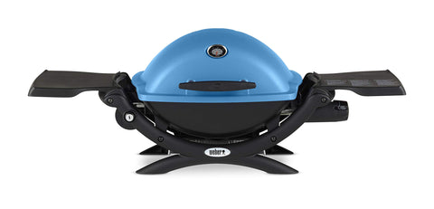 Weber Q1200 blue hood in portable setup for travel grilling.