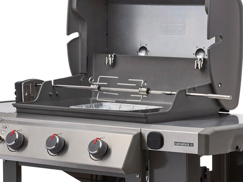Weber rotisserie chicken cooking demonstrates slow, even browning above the grate.