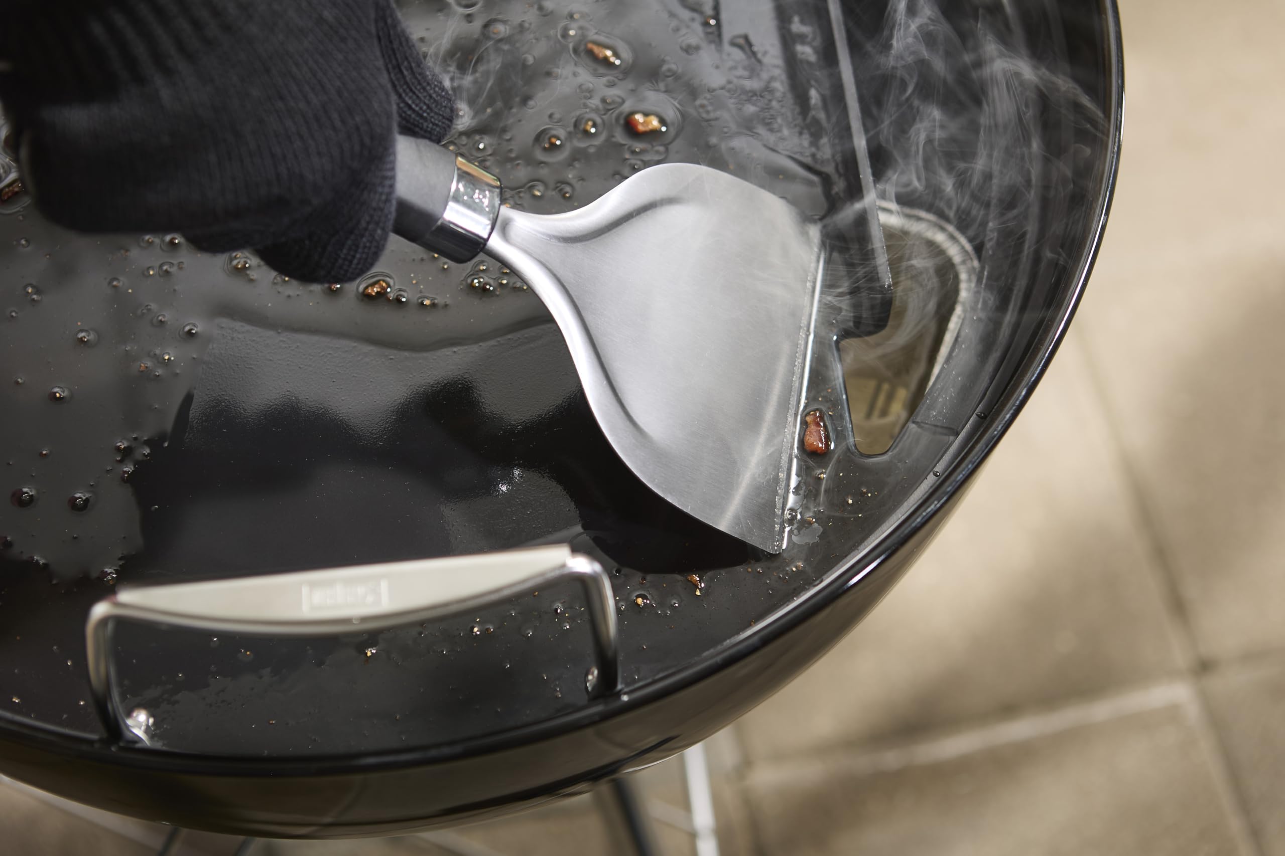 Weber round griddle insert rear grease slot close-up with backstop