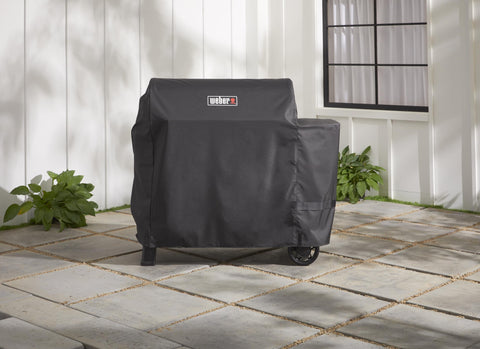 Weber Searwood 600 XL cover fastening straps detail for a secure fit.