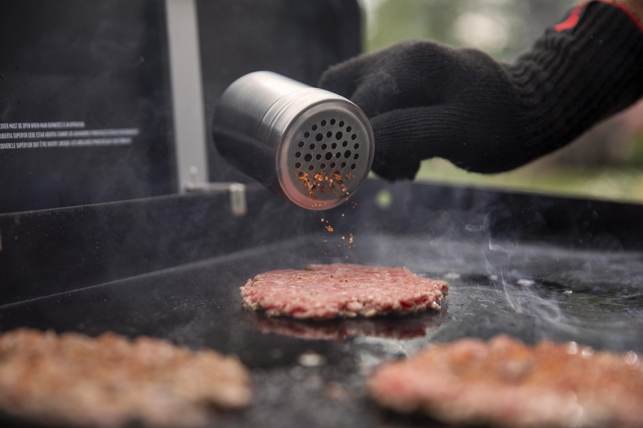 Weber Smashed Burger Ready Patties plated for serving and toppings.