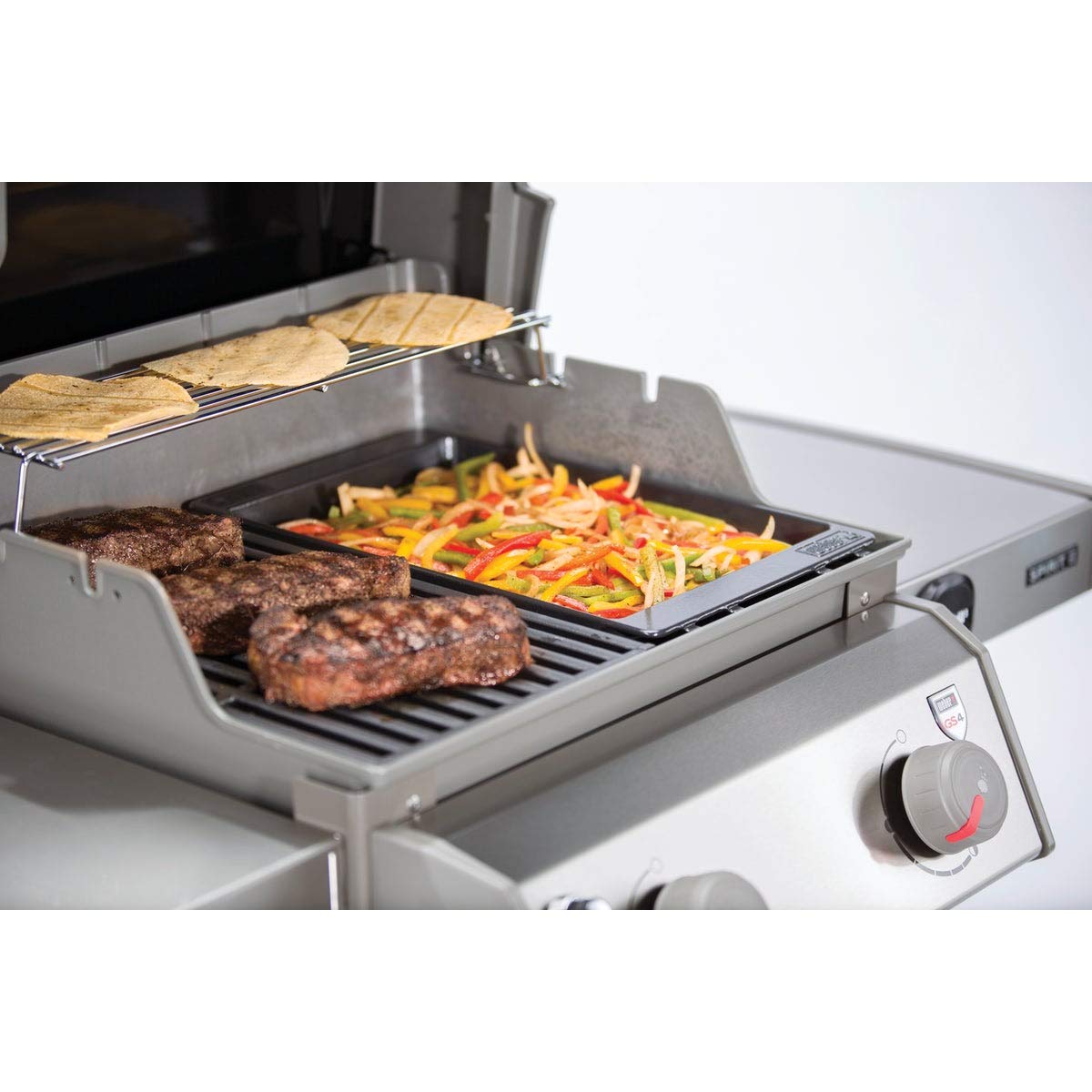 Weber Spirit griddle highlights heat retention for steady cooking.