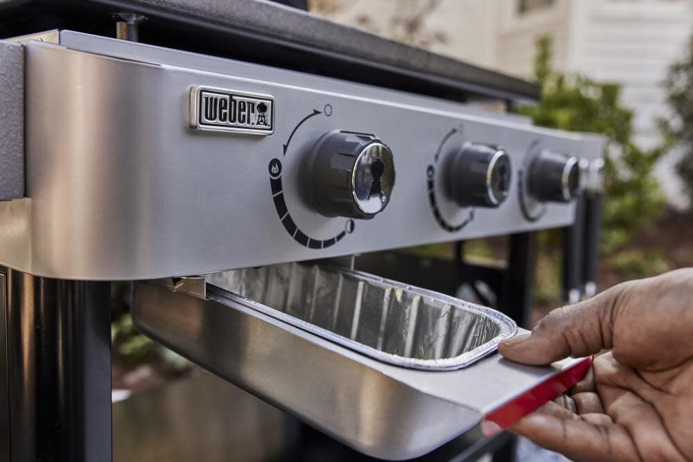 Weber stainless steel griddle scraper highlighting durable material.