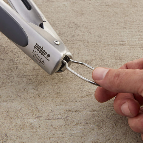 Weber tongs locking mechanism engaged for compact storage