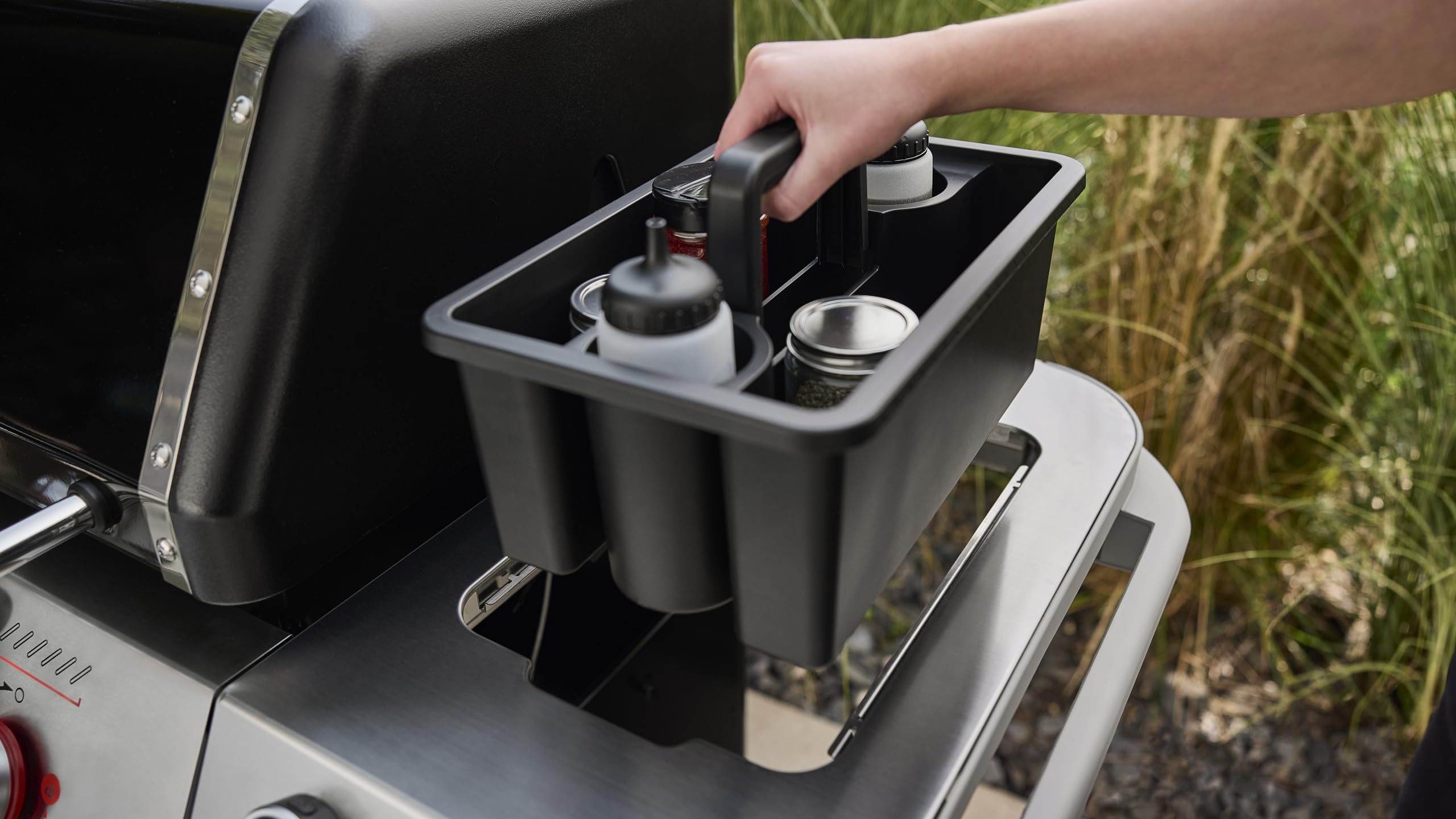 Weber Works Caddy beside sauces bottles and tools for easy reach