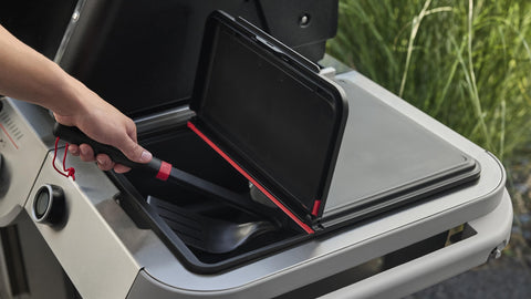 Sleek Weber Works storage bin blends with outdoor kitchen setup.