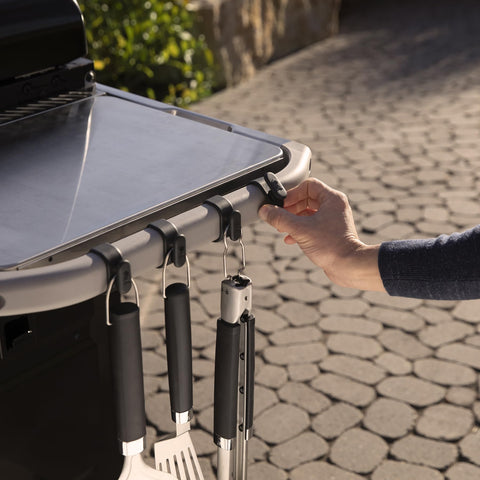 Weber Works garbage bag holder on rail keeps waste accessible while cooking.