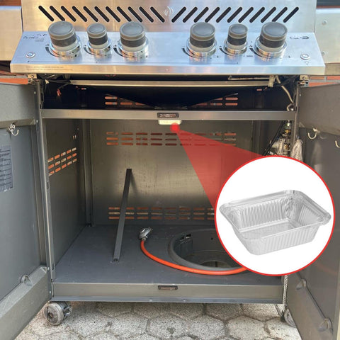 Grease-catching liner protecting grill tray during cooking.