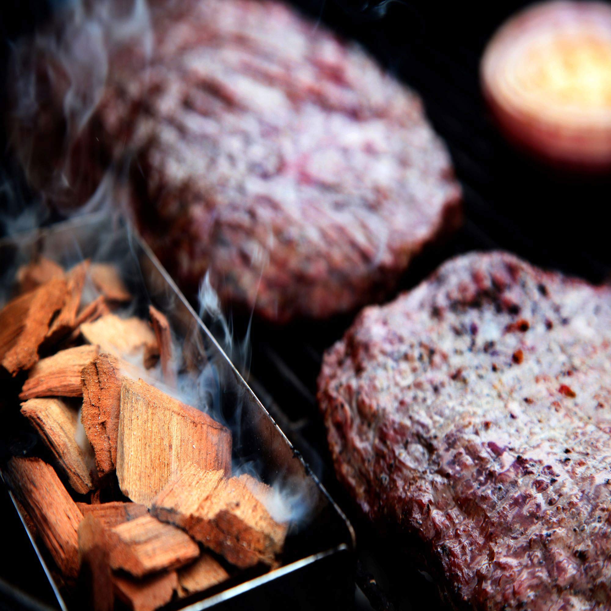 Western BBQ chips in a charcoal grill delivering visible smoke.