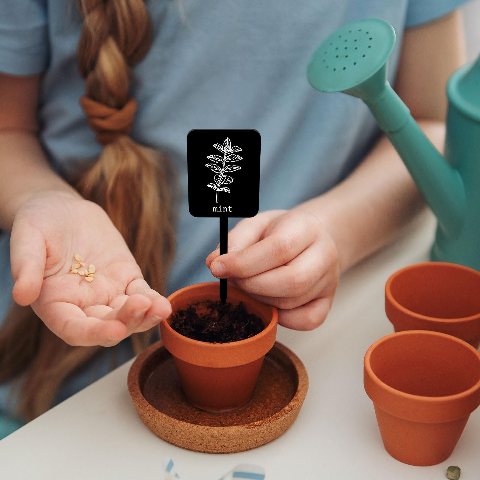 Whaline plant stake tags shown on pots for organized herbs
